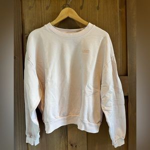 Levi’s hip length crew neck sweater. Light Pink. Size M